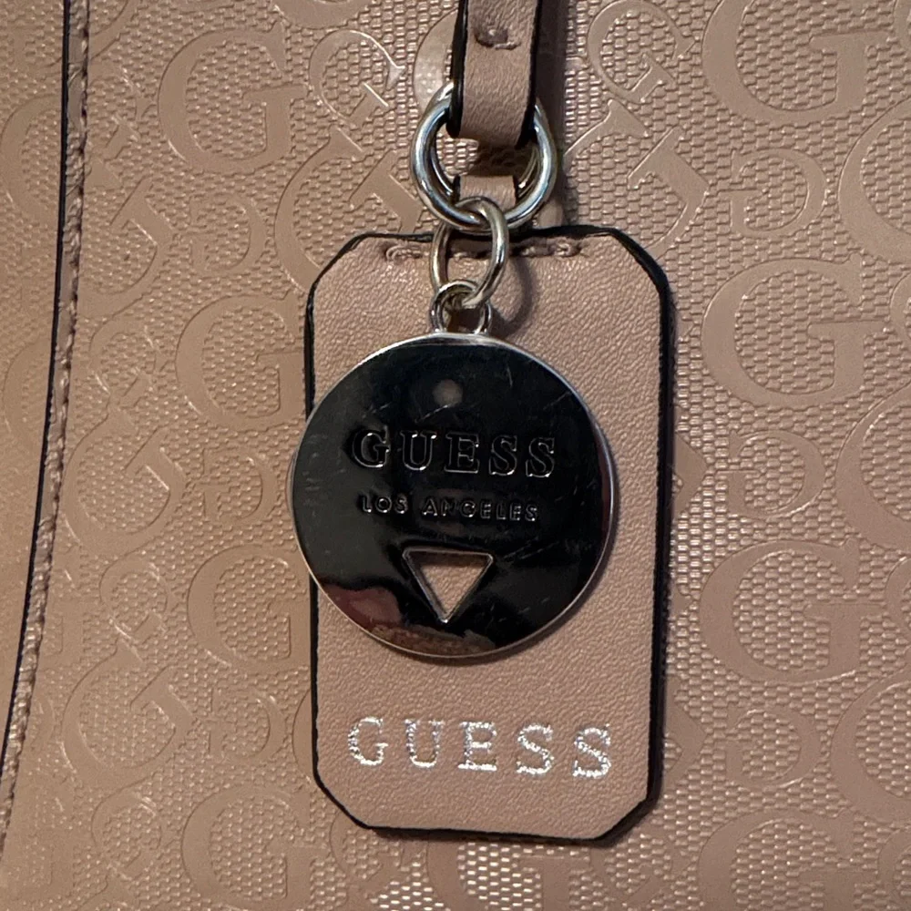 GUESS Beige Satchel Bag with crossbody strap.